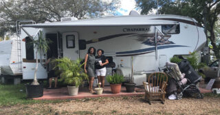 Two women in front of a new travel trailer after Hurricane Irma