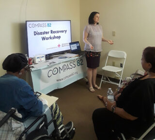 Bridget Holmes presenting in front of a small group of people 