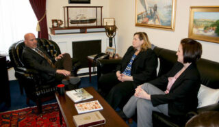 Sue Marticek and Bridget Holmes on a couch across from Congressman Tom MacArthur in his office